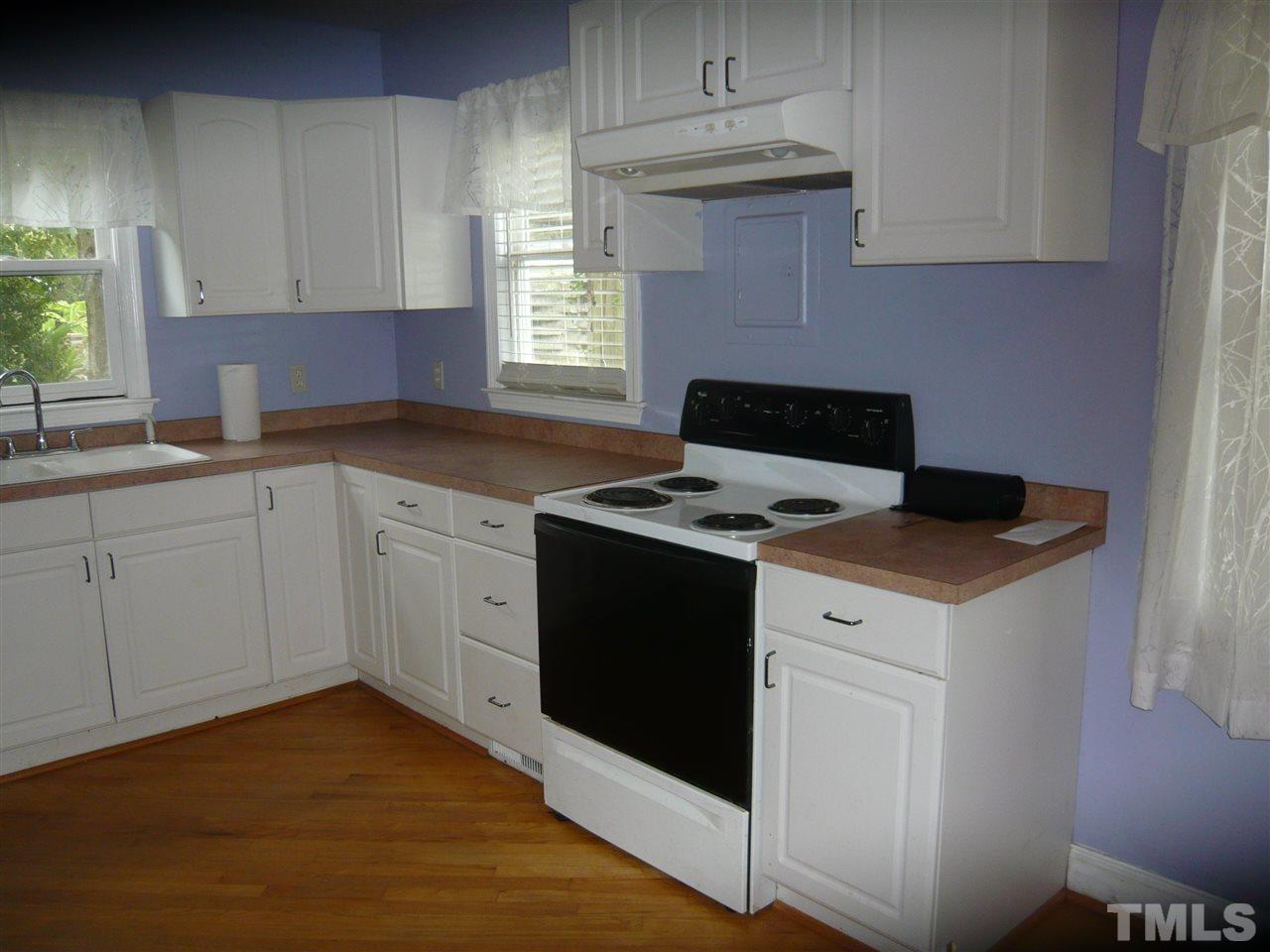 4613 Auburn Knightdale Road Raleigh, NC 27610 - Photo 15 of 25 a kitchen with a stove white cabinetry a sink and dishwasher