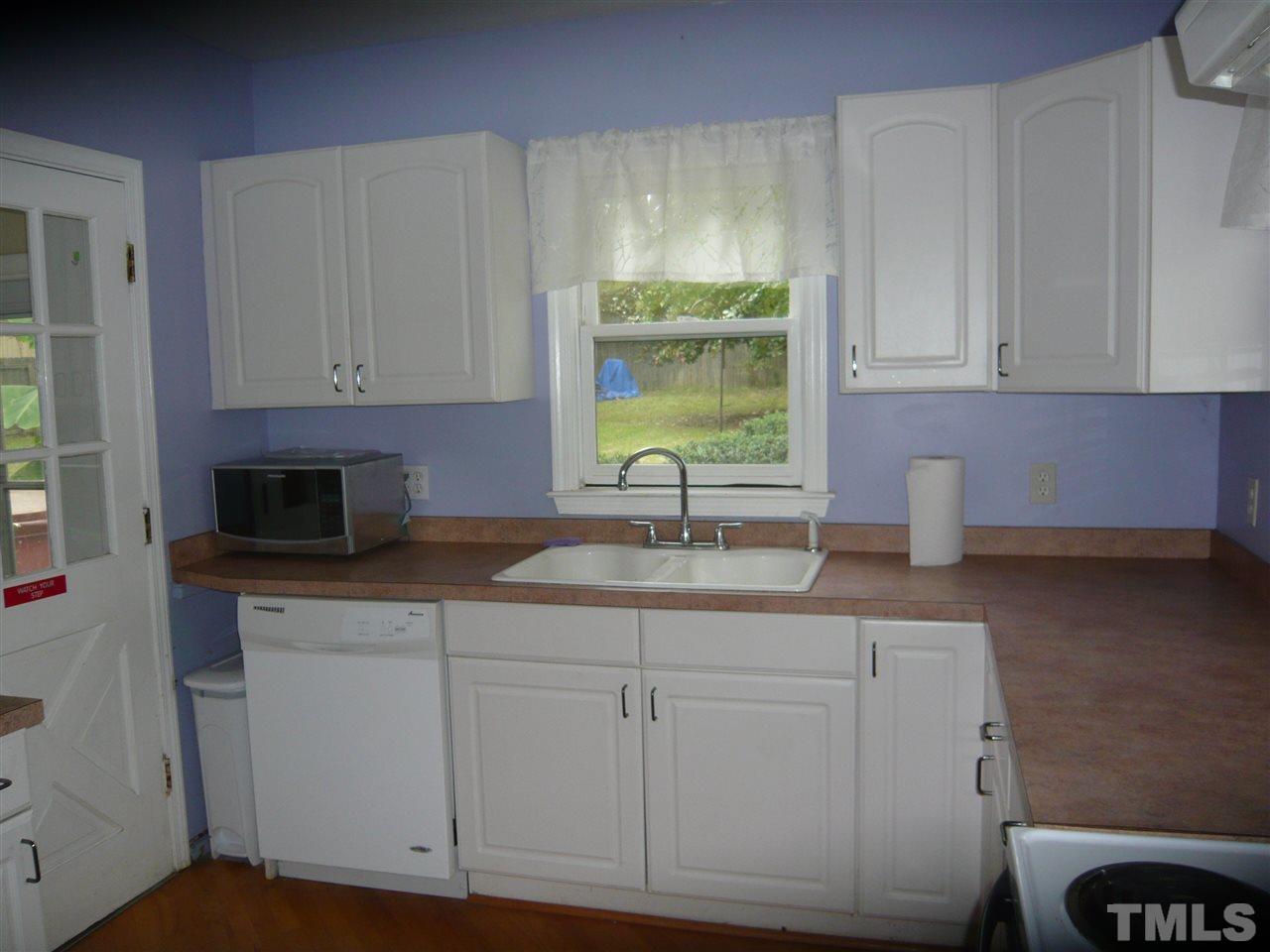 4613 Auburn Knightdale Road Raleigh, NC 27610 - Photo 16 of 25 a kitchen with white cabinets and sink