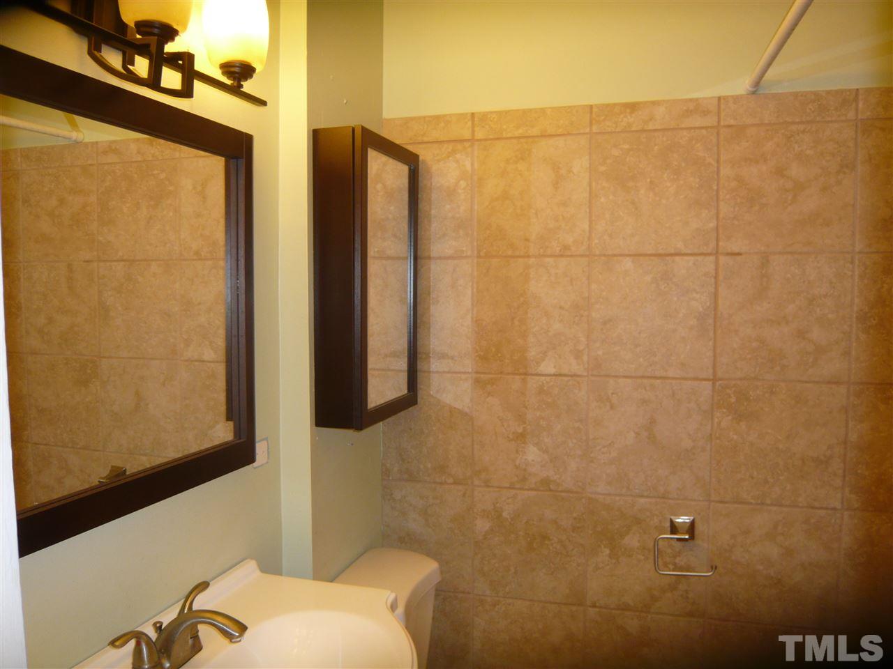 4613 Auburn Knightdale Road Raleigh, NC 27610 - Photo 18 of 25 a bathroom with a sink mirror and shower