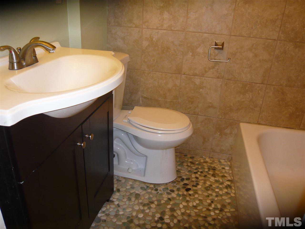 4613 Auburn Knightdale Road Raleigh, NC 27610 - Photo 19 of 25 a bathroom with a sink and a toilet