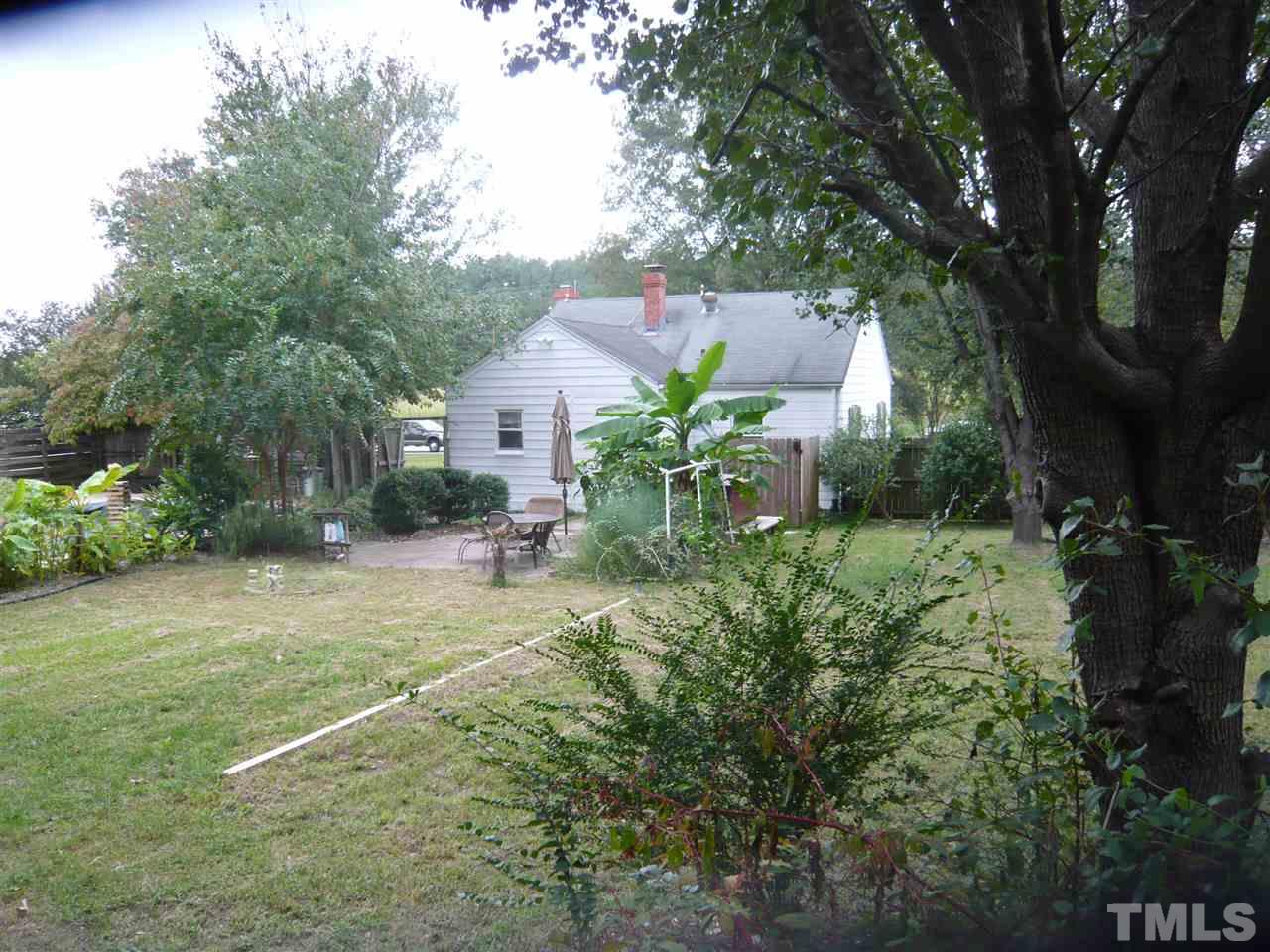 4613 Auburn Knightdale Road Raleigh, NC 27610 - Photo 9 of 25 a backyard of a house with plants and large trees