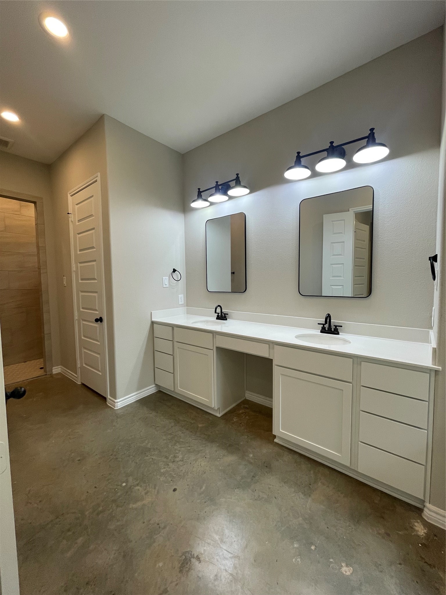 236 Dipping Vat Road Huntsville, TX 77340 - Photo 24 of 50 a bathroom with a double vanity sink and mirror