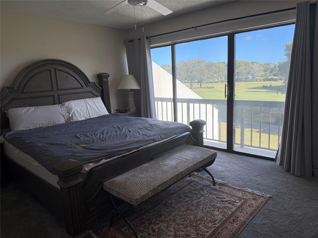 2303 Bridgewood Drive, Unit 2303 Boca Raton, FL 33434 - Photo 11 of 20 a bed sitting in a bedroom next to a window