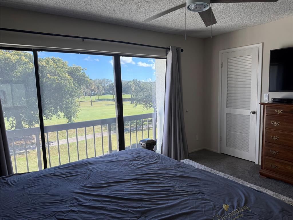 2303 Bridgewood Drive, Unit 2303 Boca Raton, FL 33434 - Photo 12 of 20 a bedroom with a bed and a large window