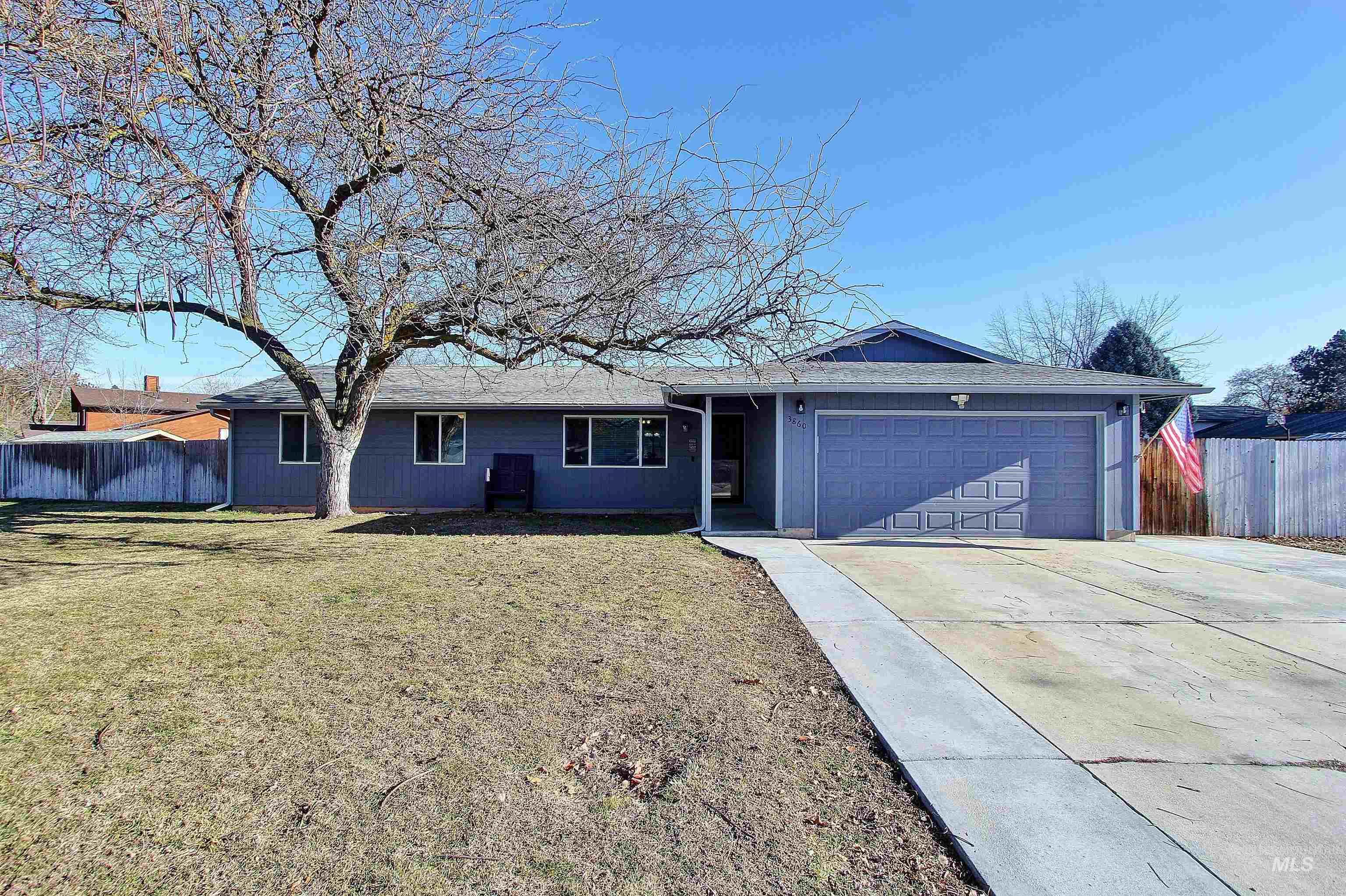 Ranch-style home with an attached garage and concrete driveway with RV parking