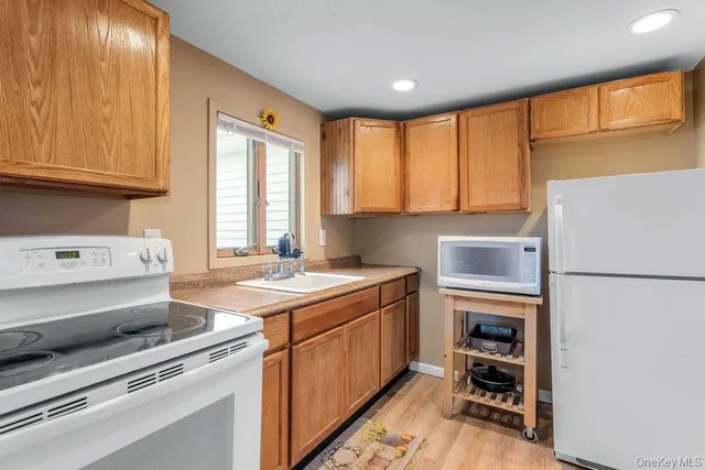 a kitchen with a stove a sink and a refrigerator