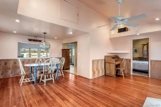 a dining room with furniture and wooden floor