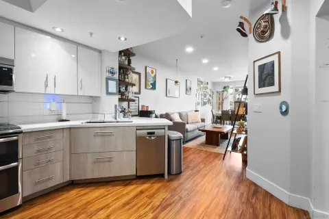 a kitchen with a sink cabinets and wooden floor