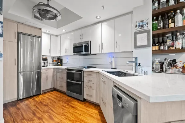a kitchen with stainless steel appliances granite countertop a stove sink and cabinets