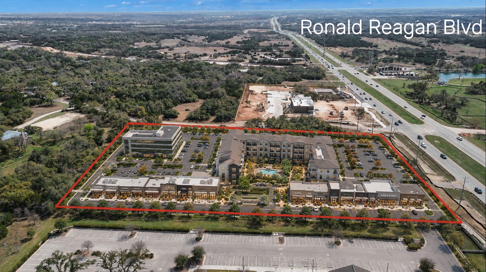 51 County Road 264 Leander, TX 78641 - Photo 3 of 17 An aerial perspective reveals a vibrant mixed-use development alongside a major thoroughfare.