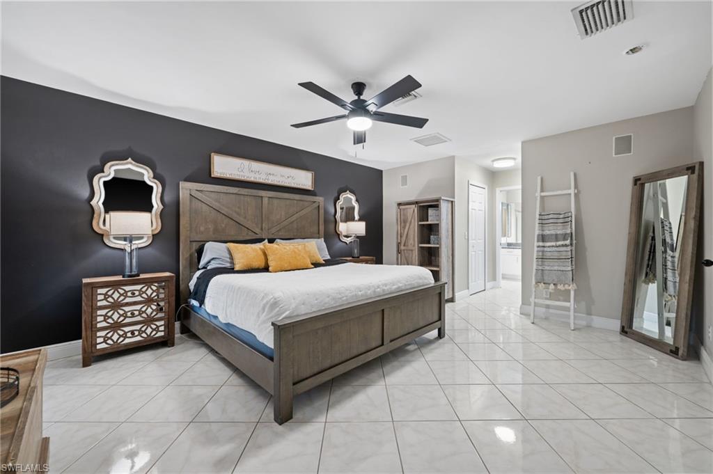 18281 Fuchsia Road Fort Myers, FL 33967 - Photo 18 of 37 a bed room with a bed and a chandelier