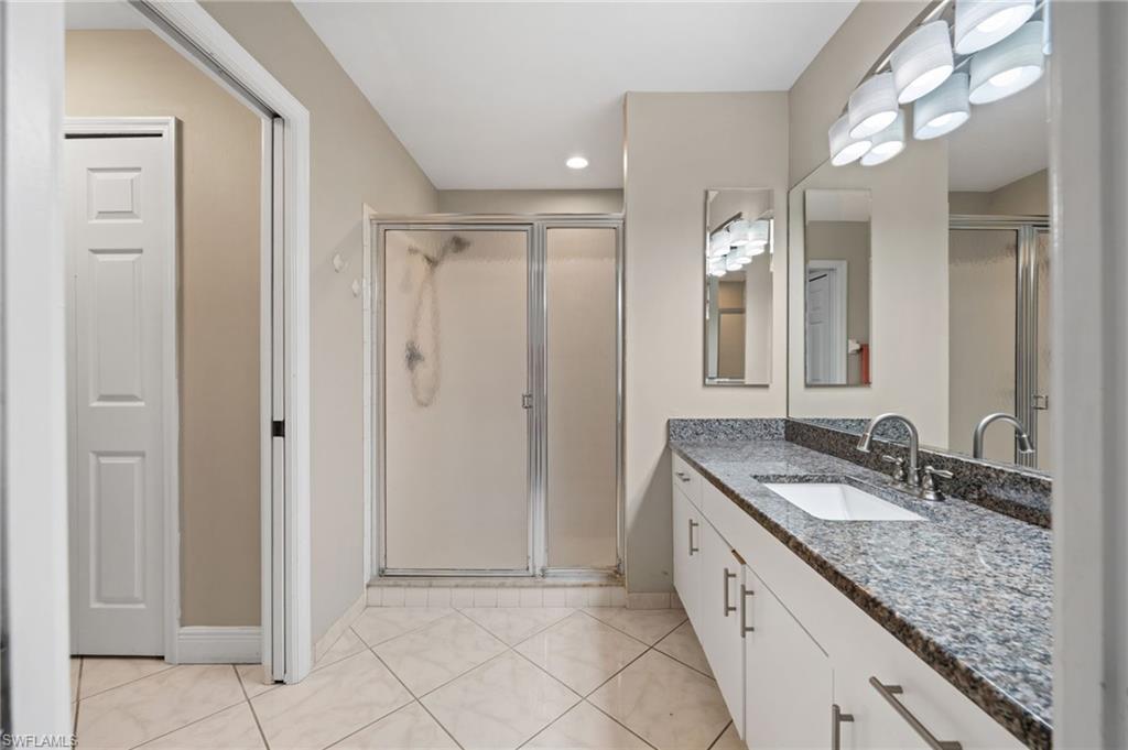 18281 Fuchsia Road Fort Myers, FL 33967 - Photo 20 of 37 a spacious bathroom with a granite countertop sink and a mirror