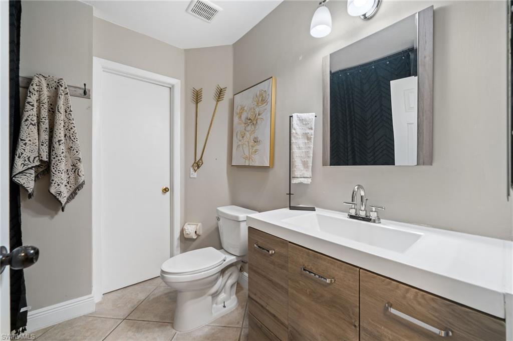 18281 Fuchsia Road Fort Myers, FL 33967 - Photo 21 of 37 a bathroom with a toilet a sink and a mirror