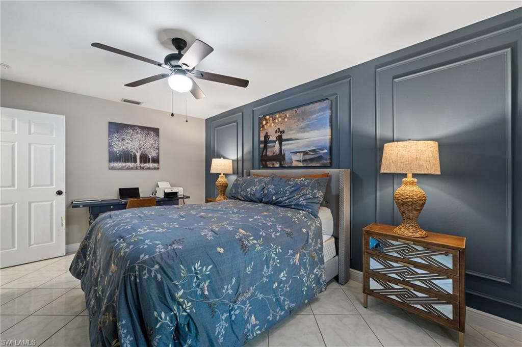 18281 Fuchsia Road Fort Myers, FL 33967 - Photo 25 of 37 a bedroom with a bed and a chandelier