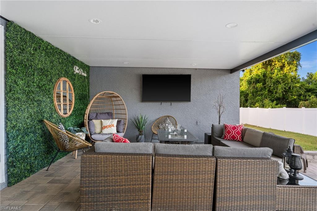 18281 Fuchsia Road Fort Myers, FL 33967 - Photo 27 of 37 a living room with furniture a flat screen tv and a large window