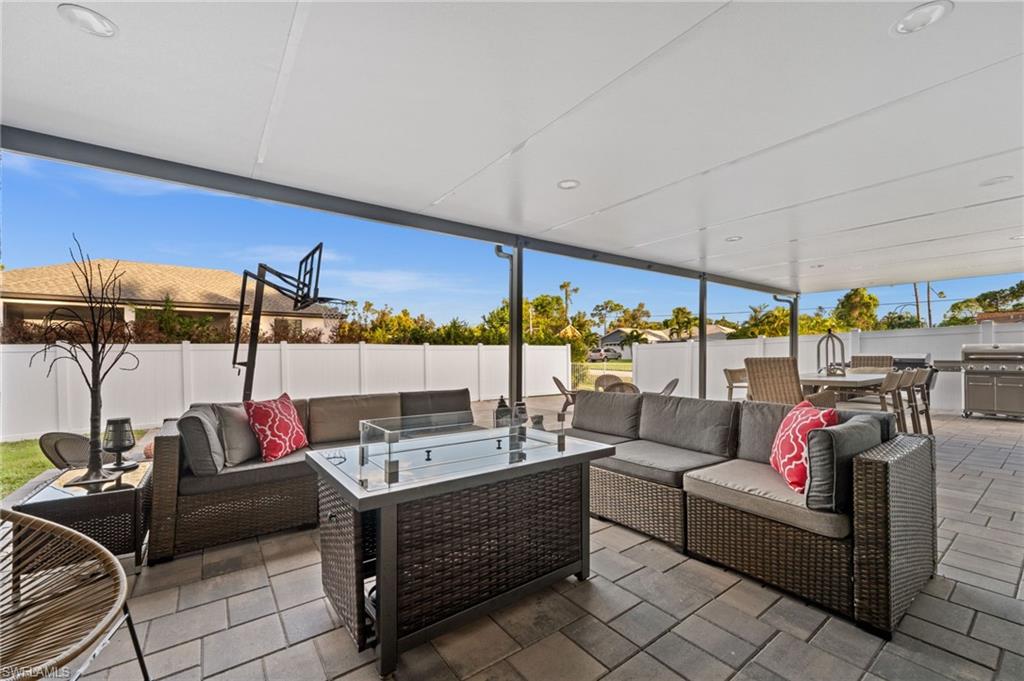 18281 Fuchsia Road Fort Myers, FL 33967 - Photo 28 of 37 a living room with furniture and a floor to ceiling window