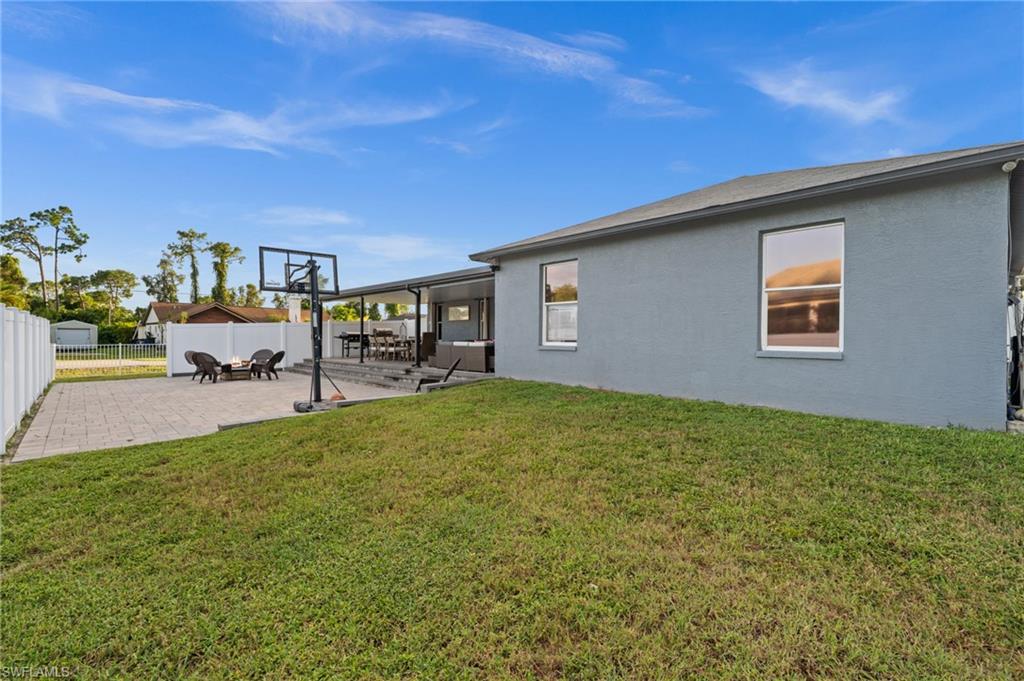 18281 Fuchsia Road Fort Myers, FL 33967 - Photo 34 of 37 a backyard of a house with table and chairs