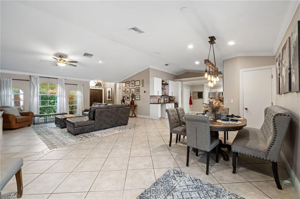 18281 Fuchsia Road Fort Myers, FL 33967 - Photo 8 of 37 a living room with furniture and a chandelier