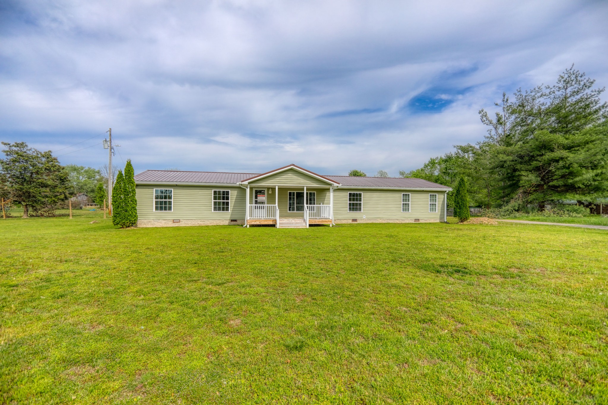 a front view of house with yard and green space