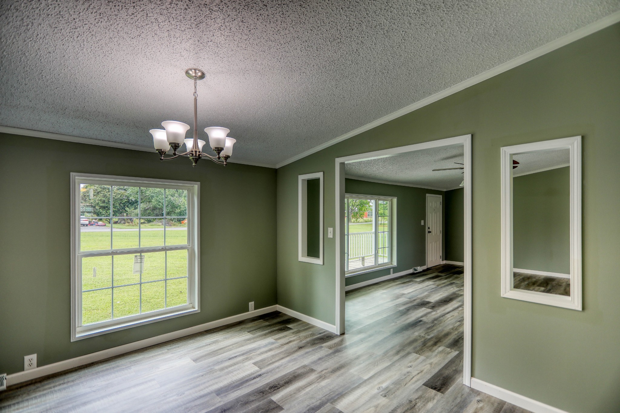 1834 Oak Grove Church Road Adolphus, KY 42120 - Photo 14 of 32 an empty room with wooden floor chandelier and windows