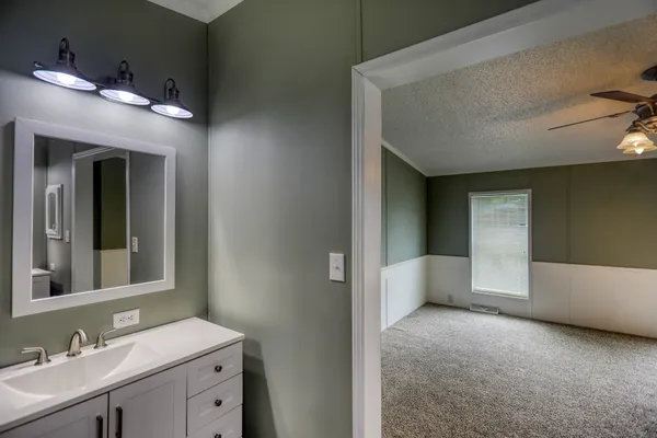 a view of an empty room with a ceiling fan