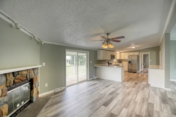 an empty room with closet and a chandelier fan