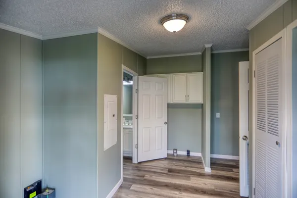 a view of a hallway with bedroom and wooden floor