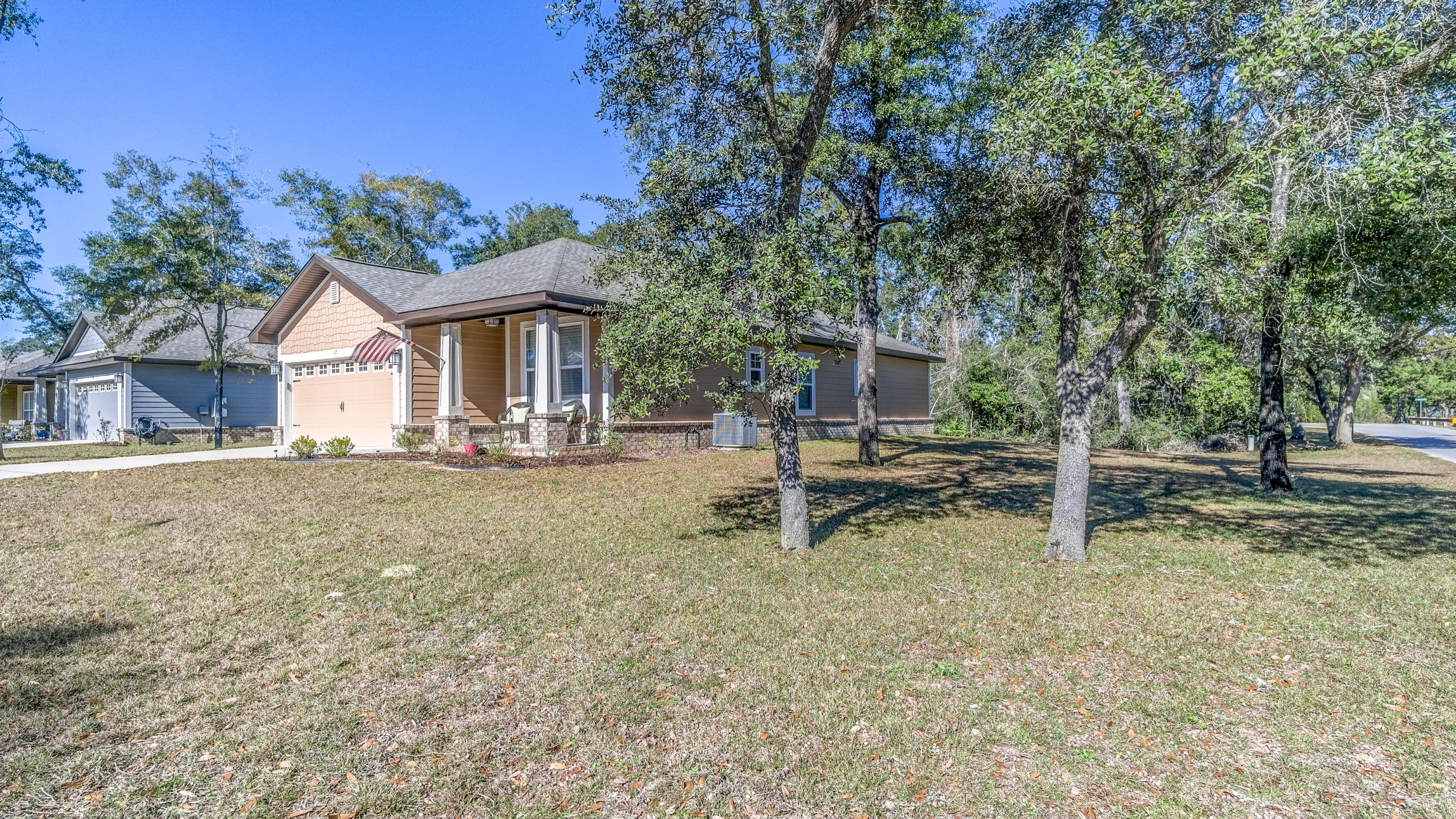 12 Benton Boulevard Freeport, FL 32439 - Photo 24 of 28 a view of a house with backyard and a tree