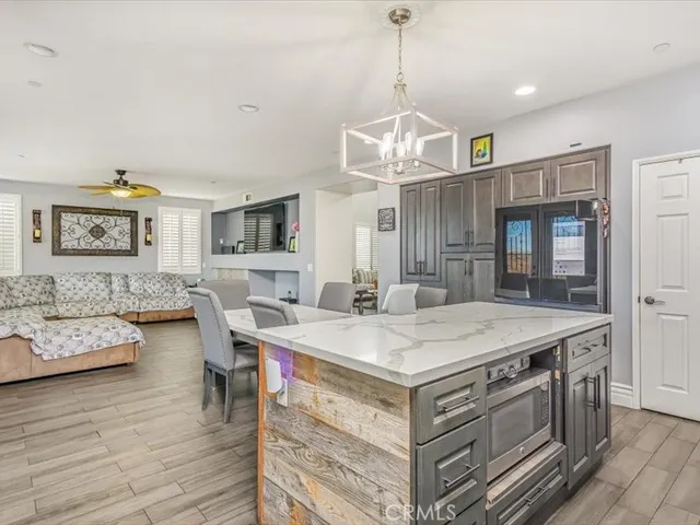 a view of a dining room with furniture wooden floor and chandelier