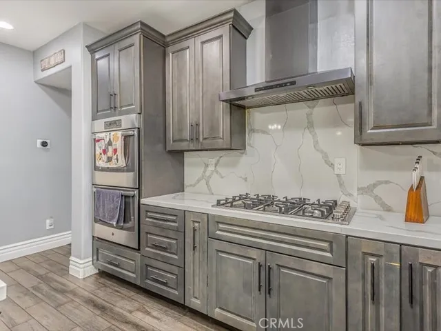 a kitchen with stainless steel appliances granite countertop a sink and cabinets