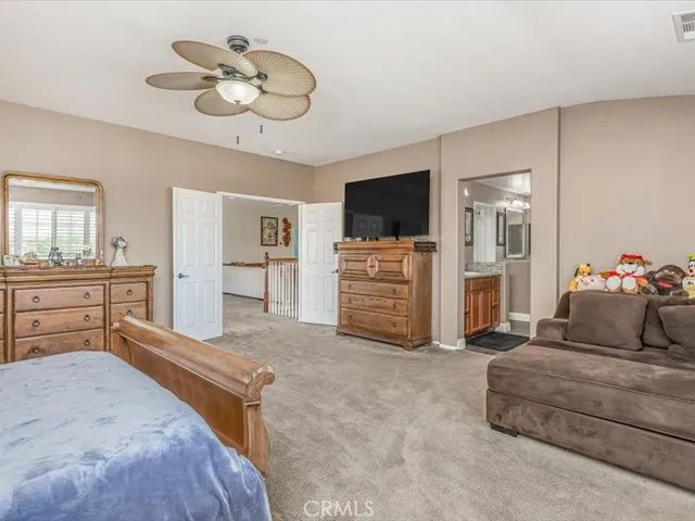 a bedroom with furniture and a flat screen tv