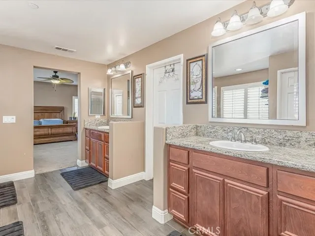 a kitchen with granite countertop a refrigerator and cabinets