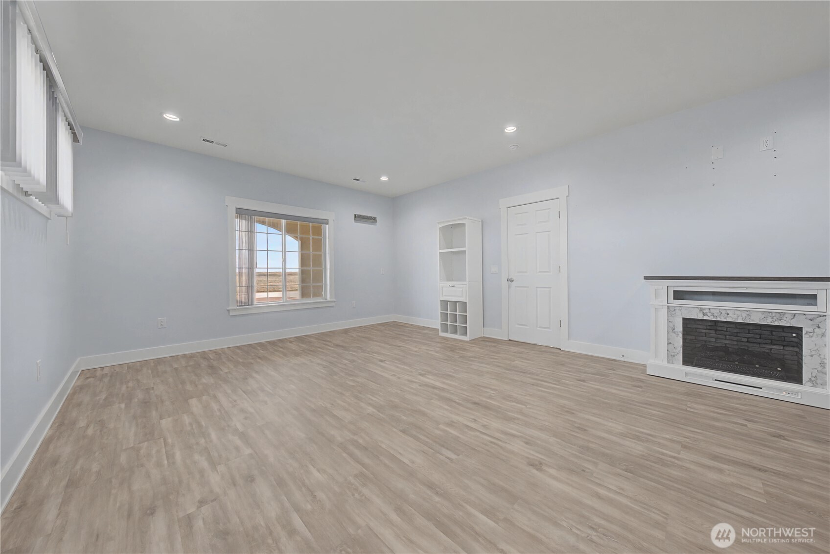 21347 Rd D.5 Soap Lake, WA 98851 - Photo 24 of 40 an empty room with windows and fireplace