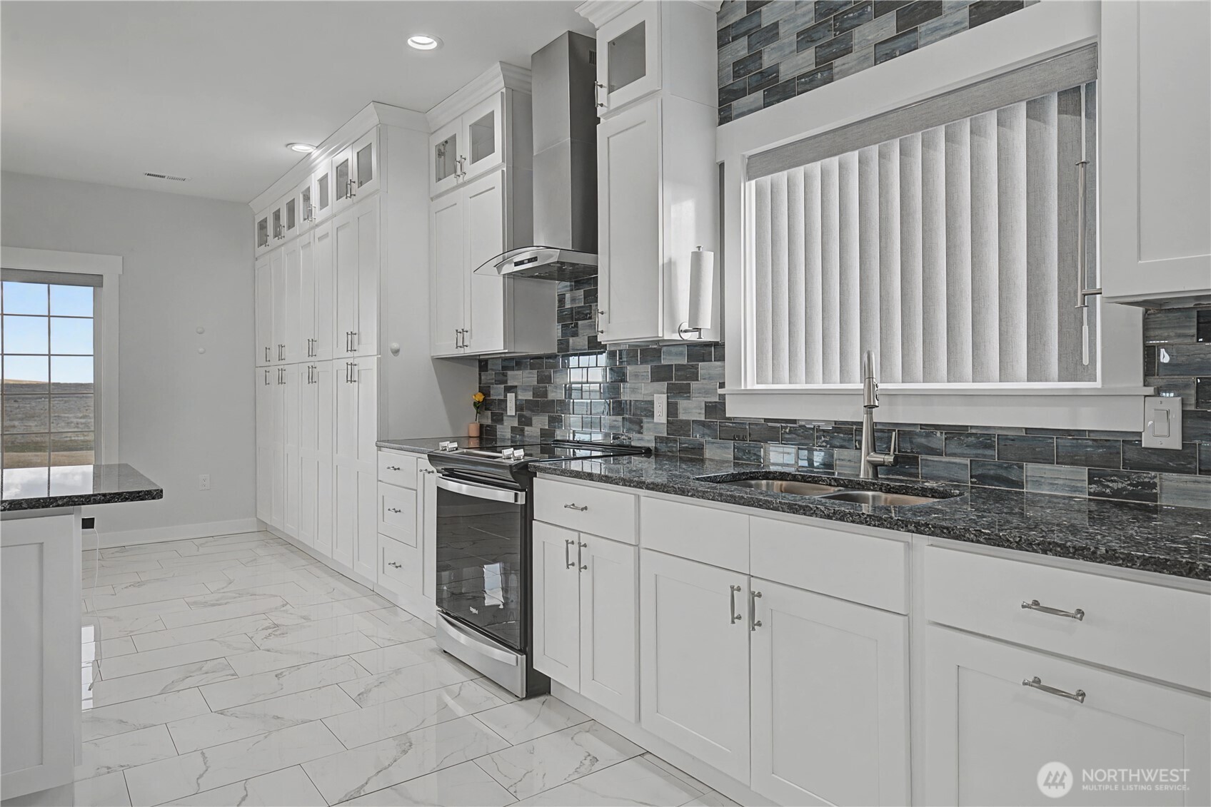 21347 Rd D.5 Soap Lake, WA 98851 - Photo 6 of 40 a kitchen with granite countertop a sink stainless steel appliances white cabinets and a window