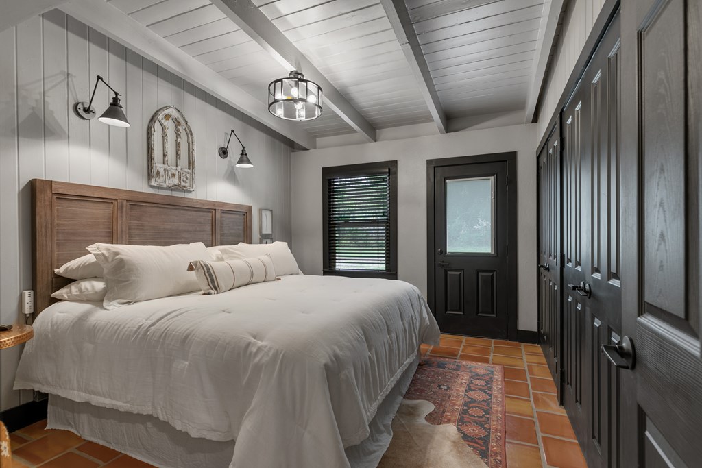 48 Kneese Road Fredericksburg, TX 78624 - Photo 12 of 43 a bed room with a bed and a large mirror