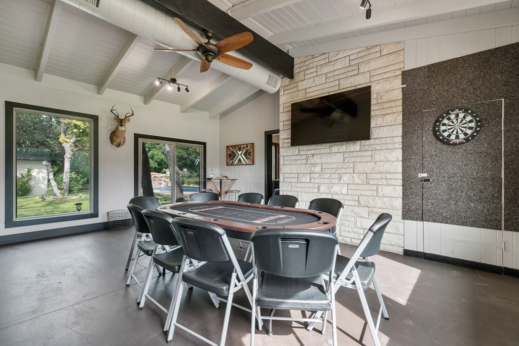 48 Kneese Road Fredericksburg, TX 78624 - Photo 15 of 43 a view of a dining room with furniture and a fireplace