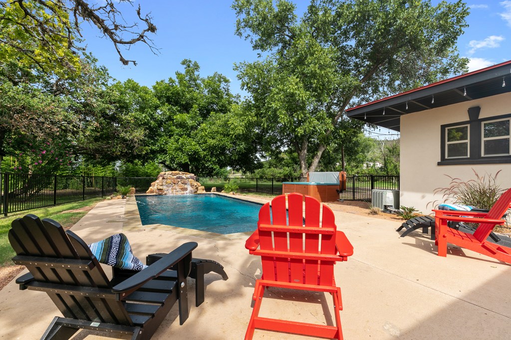 48 Kneese Road Fredericksburg, TX 78624 - Photo 19 of 43 a view of backyard with seating area and trees