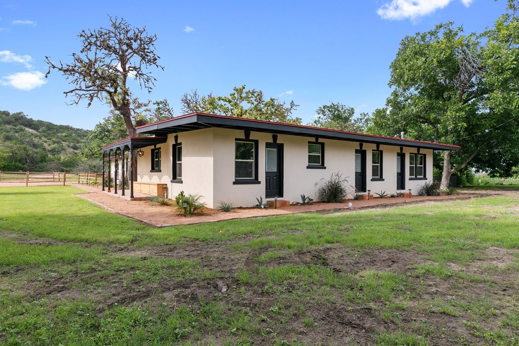 48 Kneese Road Fredericksburg, TX 78624 - Photo 24 of 43 a view of a house with backyard and a tree