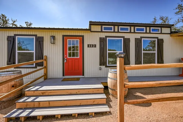 a view of a house with porch and chairs