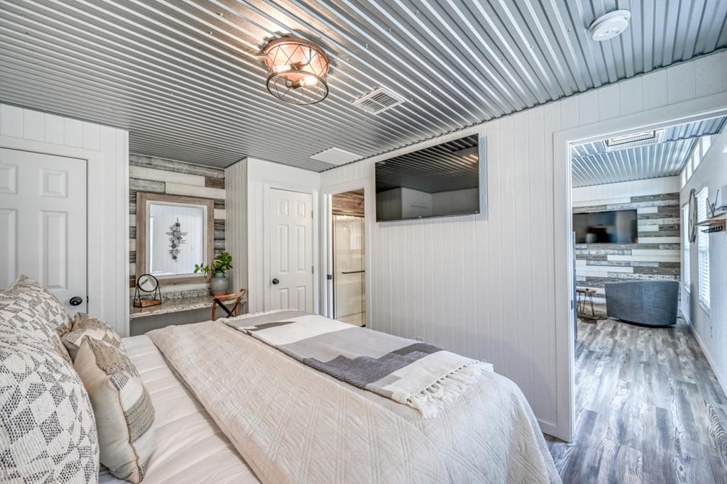 48 Kneese Road Fredericksburg, TX 78624 - Photo 34 of 43 a bedroom with a bed and a flat screen tv