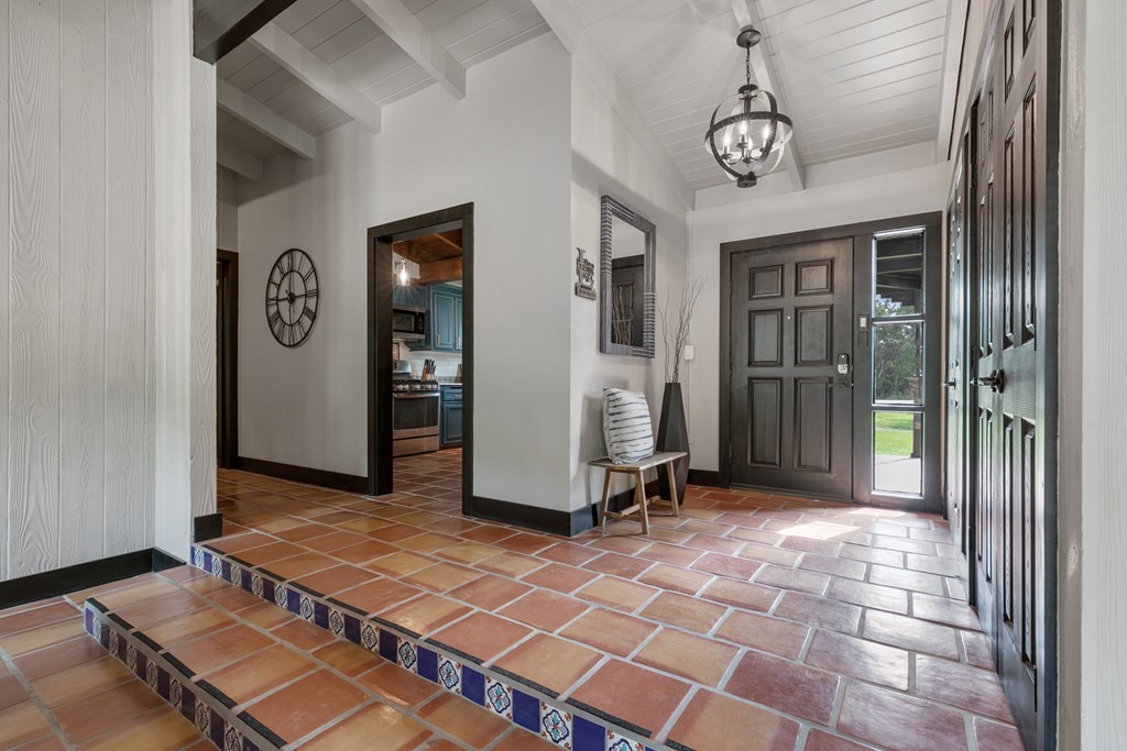 48 Kneese Road Fredericksburg, TX 78624 - Photo 4 of 43 a view of a hallway with wooden floor and a glass door