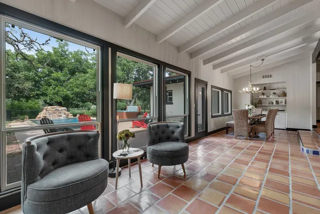 a living room with furniture and a floor to ceiling window