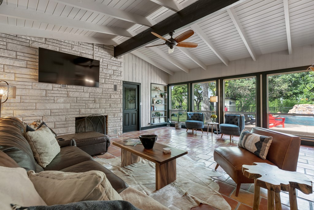 48 Kneese Road Fredericksburg, TX 78624 - Photo 7 of 43 a living room with furniture a flat screen tv and a fireplace