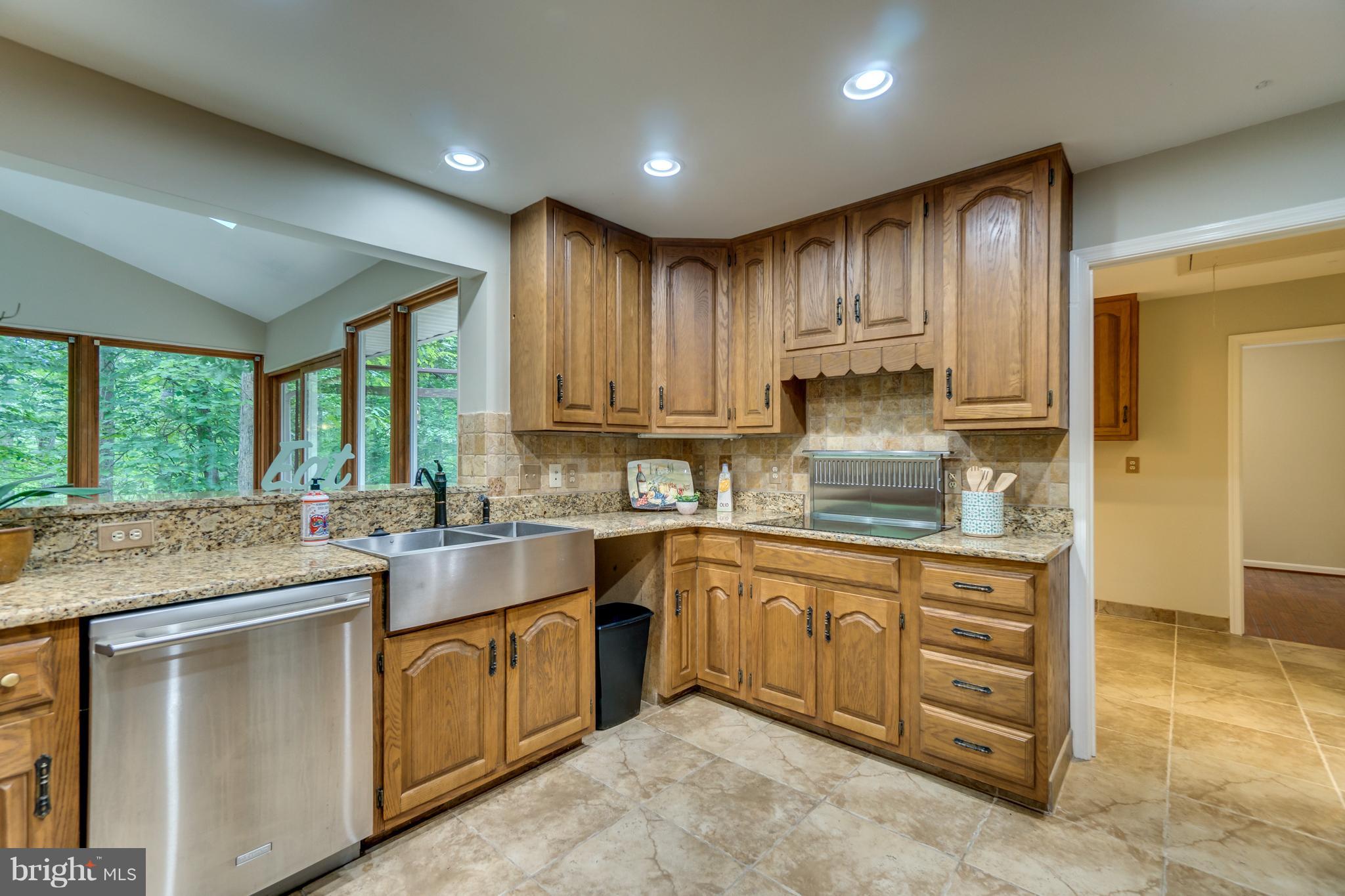 117 Bluff Point Road Fredericksburg, VA 22407 - Photo 14 of 30 a kitchen with kitchen island granite countertop a stove sink and cabinets