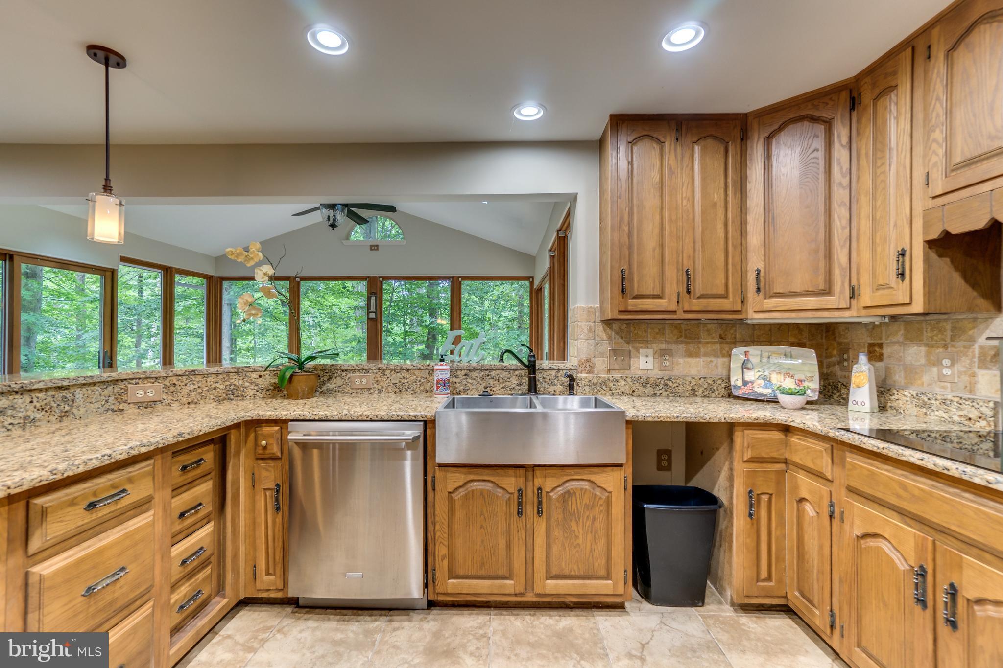 117 Bluff Point Road Fredericksburg, VA 22407 - Photo 15 of 30 a kitchen with kitchen island granite countertop a sink window and cabinets
