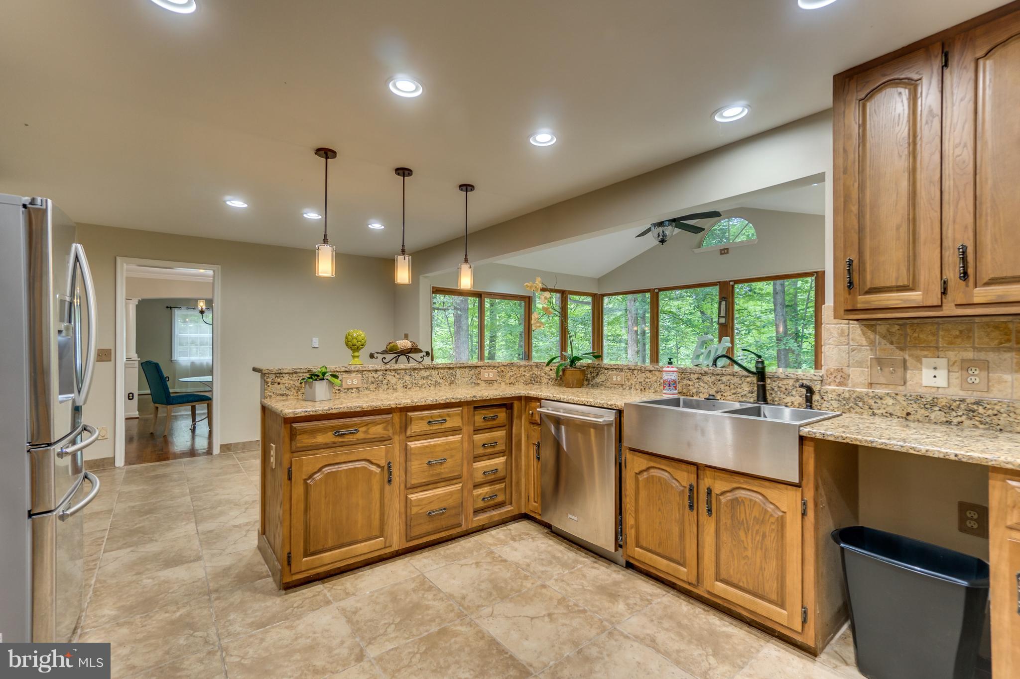 117 Bluff Point Road Fredericksburg, VA 22407 - Photo 16 of 30 a large kitchen with stainless steel appliances granite countertop a sink and cabinets