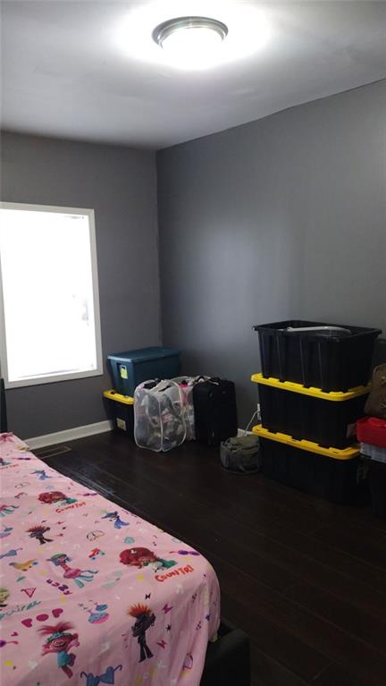 136 Hill Street Commerce, GA 30529 - Photo 19 of 27 a bedroom with a bed and a dresser