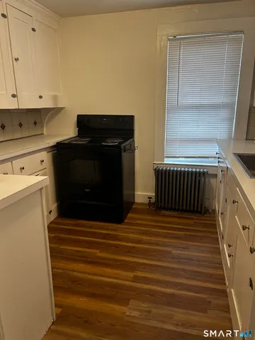a view of a utility room with wooden floor