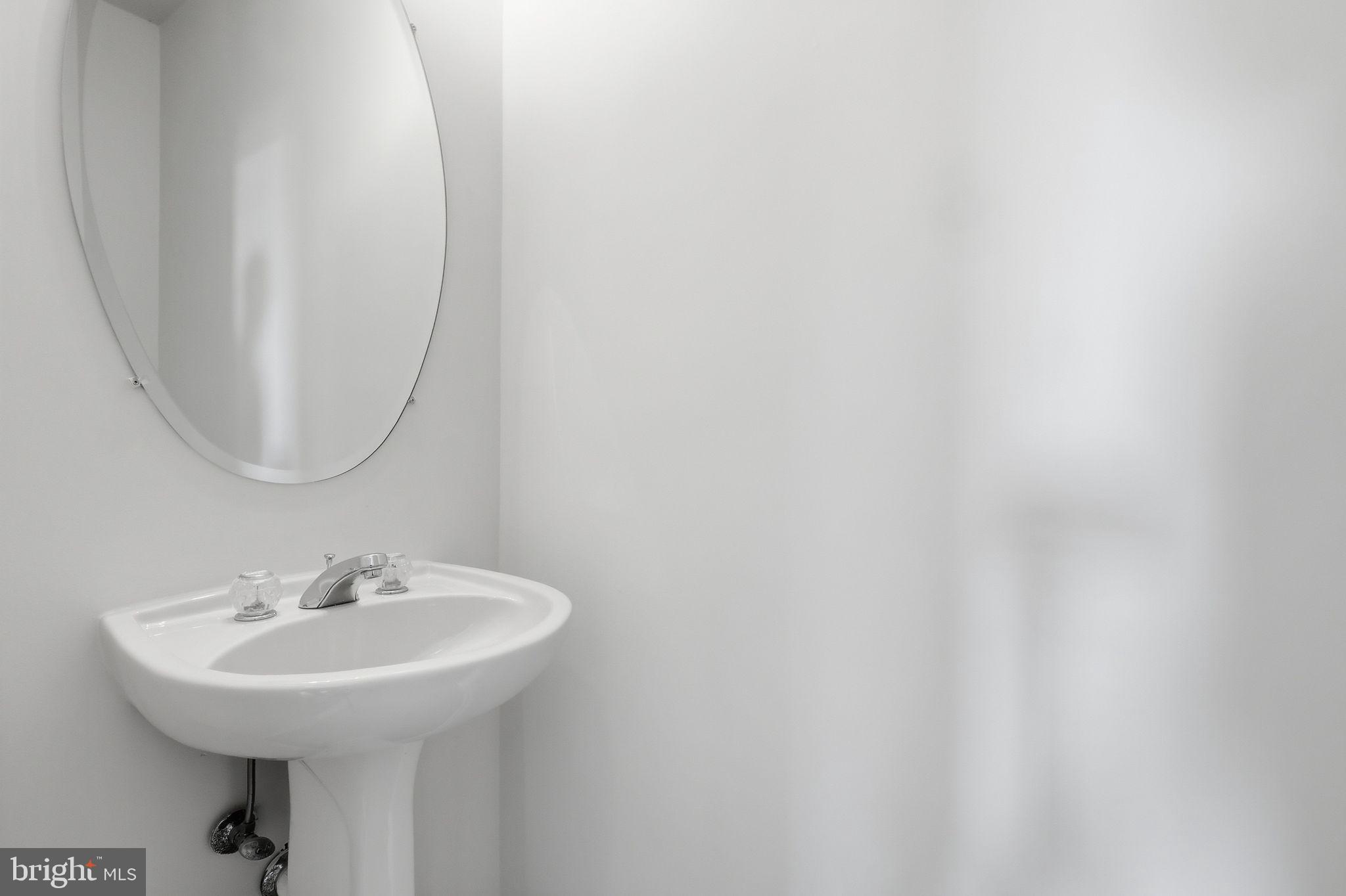 19617 Edgemont Square Ashburn, VA 20147 - Photo 24 of 65 a bathroom with a sink and a mirror