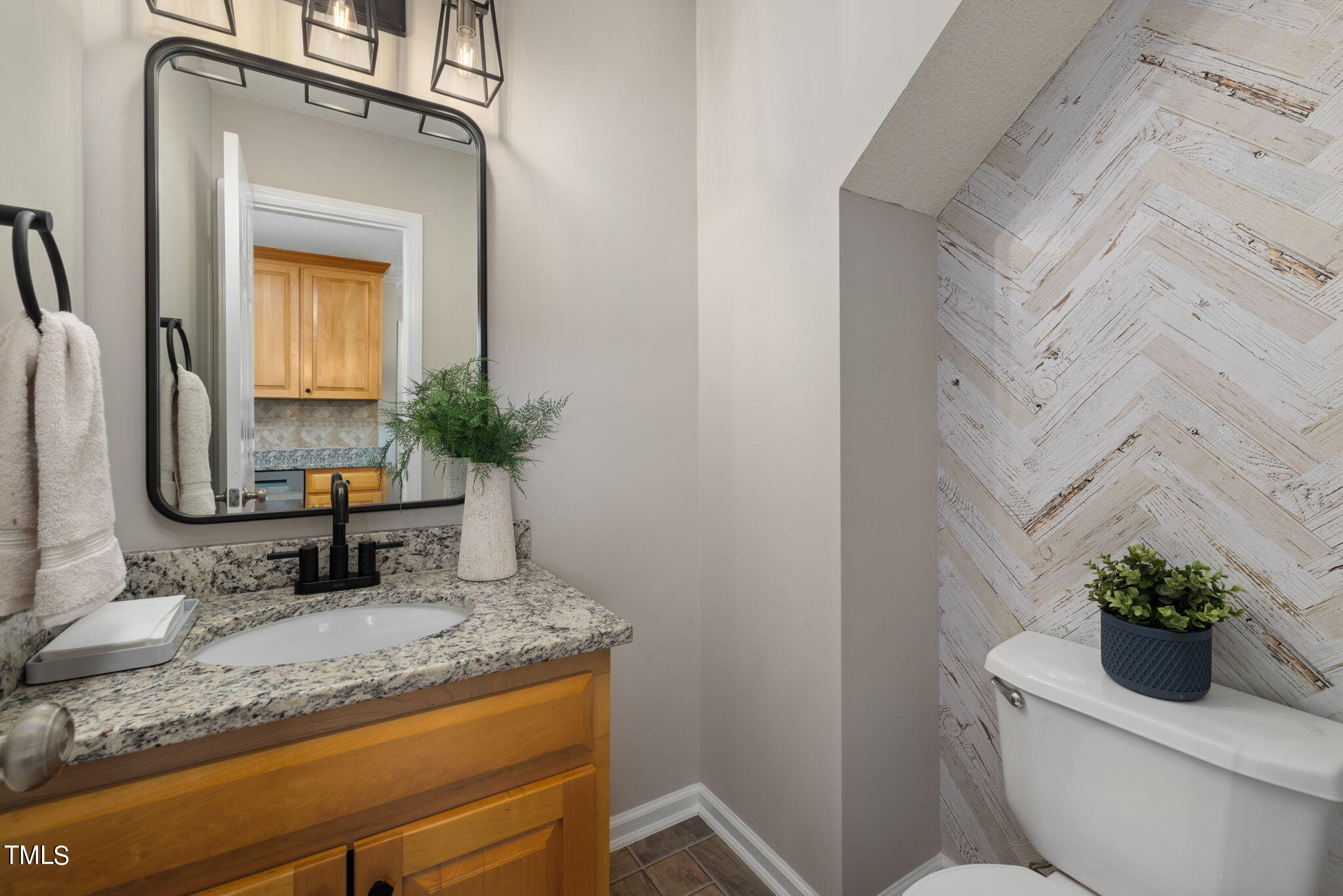 1500 Harvey Johnson Road Raleigh, NC 27603 - Photo 14 of 42 a bathroom with a granite countertop toilet a sink and mirror